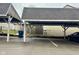 Carport parking area with unit numbers on top of each bay at 7902 Benjamin Dr, Lawrence, IN 46226