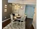 This dining room features a round table, chairs, and a stylish rug under pendant lighting at 7902 Benjamin Dr, Lawrence, IN 46226