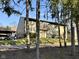 Exterior of townhome framed by mature trees, offering privacy and shade at 7902 Benjamin Dr, Lawrence, IN 46226