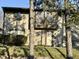 Townhome's exterior with landscaping, set against a backdrop of mature trees at 7902 Benjamin Dr, Lawrence, IN 46226