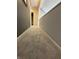 A carpeted hallway with grey walls and white trim, leading towards additional rooms at 7902 Benjamin Dr, Lawrence, IN 46226