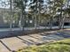 Street view of townhomes with mature trees lining the road at 7902 Benjamin Dr, Lawrence, IN 46226