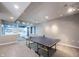 Finished basement with a Ping-Pong table, plenty of recessed lighting, and built-in shelves at 9921 N Wind River Run, McCordsville, IN 46055