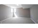 Cozy basement with neutral carpet, window, and freshly painted walls at 9921 N Wind River Run, McCordsville, IN 46055