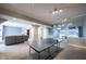 Spacious finished basement with a Ping-Pong table and a comfortable seating area for entertainment at 9921 N Wind River Run, McCordsville, IN 46055