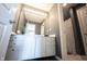 Modern bathroom with a gray wall, bright vanity lighting, and an open doorway leading to a shower at 9921 N Wind River Run, McCordsville, IN 46055