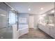 Luxurious bathroom with a glass-enclosed shower, soaking tub, and dual vanity sinks at 9921 N Wind River Run, McCordsville, IN 46055