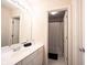 Well-lit bathroom with a white vanity, large mirror, and open doorway to the toilet and shower at 9921 N Wind River Run, McCordsville, IN 46055