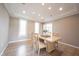 Dining room features neutral paint, recessed lighting and three windows at 9921 N Wind River Run, McCordsville, IN 46055