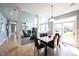 Bright dining area adjacent to the living room, featuring stylish seating and a view of the outdoors at 9921 N Wind River Run, McCordsville, IN 46055