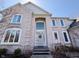 Elegant brick home featuring a welcoming entryway with large windows and a classic front door with wreath at 9921 N Wind River Run, McCordsville, IN 46055