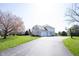 Two-story home with a three-car garage and a long driveway at 9921 N Wind River Run, McCordsville, IN 46055