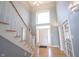 Grand foyer with soaring ceilings, hardwood floors, and a striking staircase leading to the upper level at 9921 N Wind River Run, McCordsville, IN 46055