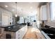 Bright kitchen featuring stainless appliances, white cabinetry, granite counters and backsplash, and a spacious island at 9921 N Wind River Run, McCordsville, IN 46055