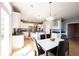 Bright kitchen boasts white cabinets, stainless appliances, granite counters, and a spacious island with connecting dining area at 9921 N Wind River Run, McCordsville, IN 46055