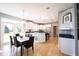 Modern kitchen with white cabinets, granite countertops, stainless steel appliances, and a dining area at 9921 N Wind River Run, McCordsville, IN 46055