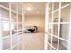 Carpeted Living room with French Doors at 9921 N Wind River Run, McCordsville, IN 46055
