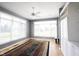 Bright living room features large windows, neutral paint and flooring at 9921 N Wind River Run, McCordsville, IN 46055