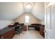 Attic office space with built-in desk and storage and a large chair at 9921 N Wind River Run, McCordsville, IN 46055