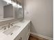 Bathroom with double vanity, white countertops and cabinetry, and modern fixtures at 10225 Bayton Ct, Indianapolis, IN 46229