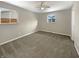 Neutral bedroom features hardwood floors, two large windows, and a ceiling fan at 10225 Bayton Ct, Indianapolis, IN 46229