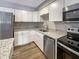 Modern kitchen featuring granite countertops, stainless steel appliances, and white cabinets at 10225 Bayton Ct, Indianapolis, IN 46229
