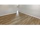 Hardwood floor in an empty room with neutral walls and baseboards at 10225 Bayton Ct, Indianapolis, IN 46229