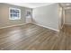 Bright living room featuring hardwood floors, neutral walls, a front door and a large window at 10225 Bayton Ct, Indianapolis, IN 46229
