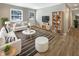 Bright and airy living room featuring contemporary furnishings, hardwood floors, and a view of the front yard at 10225 Bayton Ct, Indianapolis, IN 46229