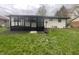 Backyard view featuring sunroom addition with floor to ceiling windows and large backyard at 10225 Bayton Ct, Indianapolis, IN 46229