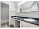 Bathroom featuring double vanity with white cabinets, updated countertops, and a shower/tub combo at 10249 Southwind Dr, Indianapolis, IN 46256
