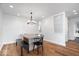 Bright dining room with hardwood floors, stylish lighting, and a modern aesthetic at 10249 Southwind Dr, Indianapolis, IN 46256