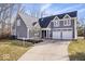 Inviting two-story home featuring a well-manicured lawn and an attached two-car garage at 10249 Southwind Dr, Indianapolis, IN 46256