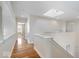Upstairs hallway with hardwood floors and natural light from the skylight at 10249 Southwind Dr, Indianapolis, IN 46256