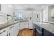 Bright kitchen featuring white cabinets, updated appliances, and concrete countertops at 10249 Southwind Dr, Indianapolis, IN 46256