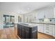 Open kitchen with a center island, white cabinets, and stainless steel appliances at 10249 Southwind Dr, Indianapolis, IN 46256