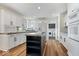 Modern kitchen with white cabinets, stainless steel appliances, and hardwood floors at 10249 Southwind Dr, Indianapolis, IN 46256