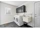Functional laundry room with washer, dryer, sink, and cabinet storage at 10249 Southwind Dr, Indianapolis, IN 46256