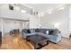 Cozy living room with a large grey sofa, hardwood floors, and abundant natural light at 10249 Southwind Dr, Indianapolis, IN 46256