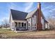 Charming home showcasing a brick chimney and a screened porch with a bench seat at 10249 Southwind Dr, Indianapolis, IN 46256