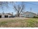 View of the backyard showing the blue house and other outbuildings and vehicles at 1039 S Ohio St, Martinsville, IN 46151