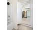 Cozy bathroom showcasing a shower and tub combination, doorway leading to kitchen at 1039 S Ohio St, Martinsville, IN 46151