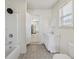 Full bathroom featuring a bathtub and shower, single sink vanity, and a bright window at 1039 S Ohio St, Martinsville, IN 46151