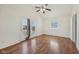 Bright bedroom featuring hardwood floors, a ceiling fan, and double doors at 1039 S Ohio St, Martinsville, IN 46151