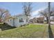 Exterior shot highlighting its light blue siding and proximity to surrounding greenery and neighborhood charm at 1039 S Ohio St, Martinsville, IN 46151
