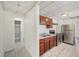 Kitchen with wood cabinets, stainless steel appliances, double sink, and tile floor at 1039 S Ohio St, Martinsville, IN 46151