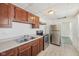 Cozy kitchen features wood cabinets, stainless steel appliances, and double basin sink at 1039 S Ohio St, Martinsville, IN 46151