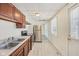 Kitchen with stainless steel refrigerator, range, double sink, and tile floor at 1039 S Ohio St, Martinsville, IN 46151