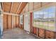 Enclosed porch with exposed wood, a door to the outside and windows bringing in natural light at 1039 S Ohio St, Martinsville, IN 46151