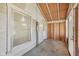 Enclosed porch showcasing exposed beams, window views, a light, and a door to the outside at 1039 S Ohio St, Martinsville, IN 46151